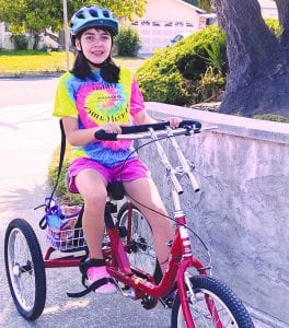 Student riding a bike for MAC